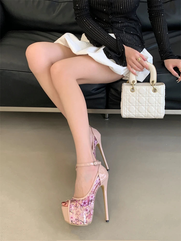 Person wearing high-heeled shoes with floral design, holding a small handbag.