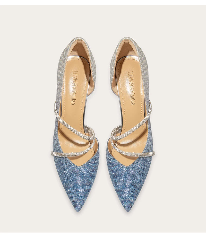 Pair of blue pointed-toe shoes with strappy design on a light gray background