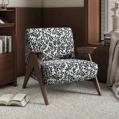 Chair with black and white pattern in a room with books and decor