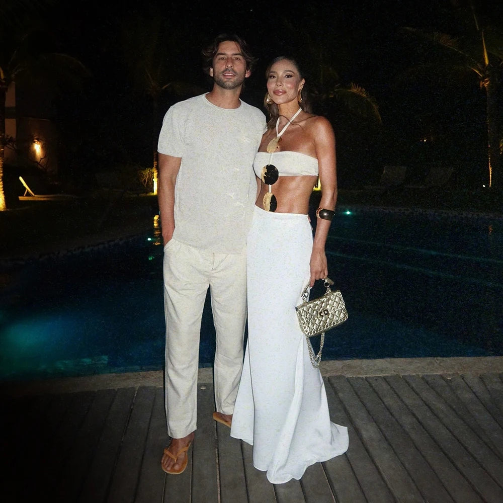 Couple posing by pool in white swimwear