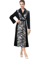 Model posing in a velvet floral embroidered midi dress