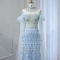 Mannequin displaying  the light blue mermaid evening gown with cape sleeves, showcasing its flattering silhouette and graceful train.  Golden Atelier 4