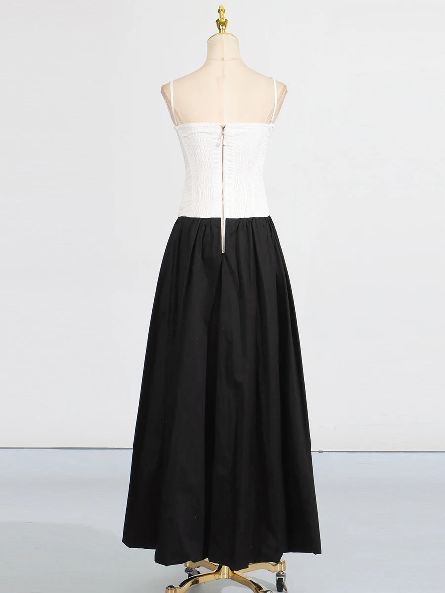 White top and black skirt on a mannequin against a white background