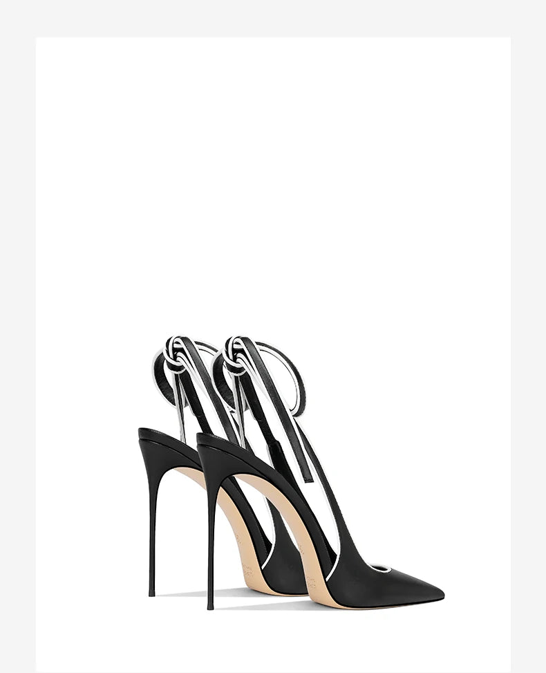 Black high-heeled shoes with clear straps on a white background