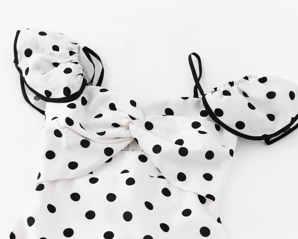 Close-up of the ruched bodice and ruffled sleeves of a polka dot dress