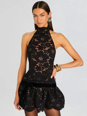 Close-up of the black lace fabric and velvet bow on the mini dress.