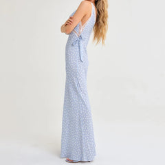 Woman wearing a light blue polka dot dress on a white background