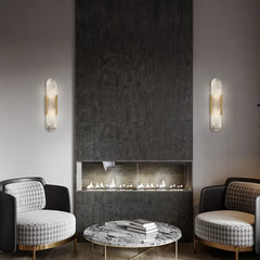 A luxurious hotel room featuring a pair of marble wall sconces, creating a relaxing and sophisticated ambiance. 