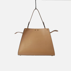 Leather trapezoid top handle bag from the back.