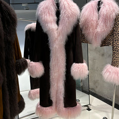 Fur coat with pink fur trim on a mannequin in a store setting.