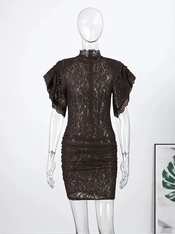 Black lace dress on a mannequin against a white background