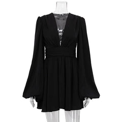 Black dress with long sleeves on a mannequin against a white background