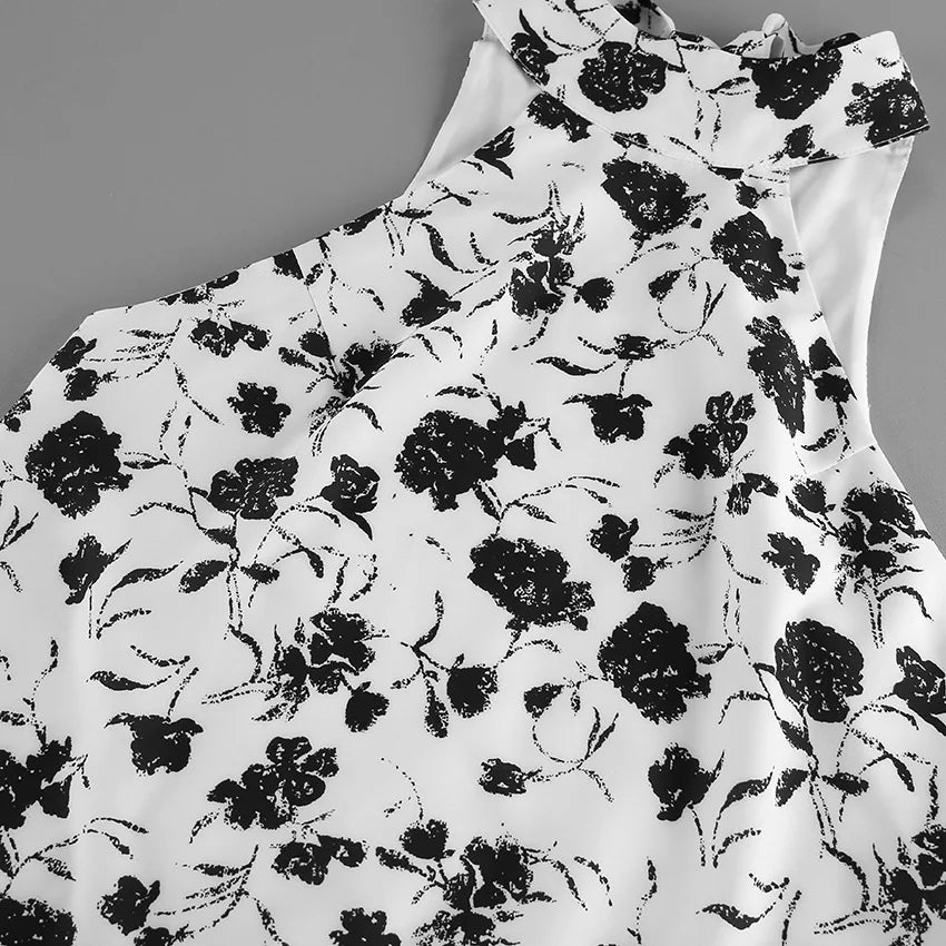 White dress with black floral pattern on a gray background