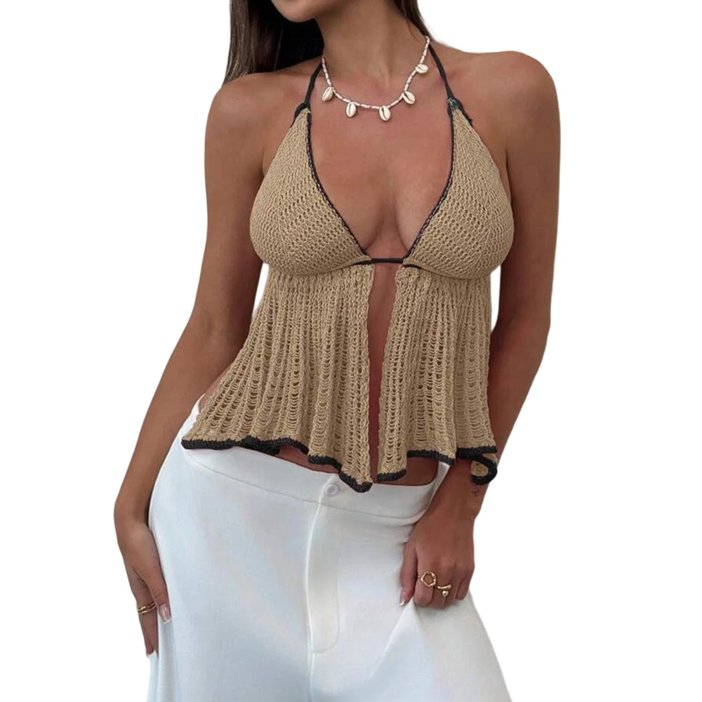 Woman wearing a beige crochet halter top with white pants on a white background