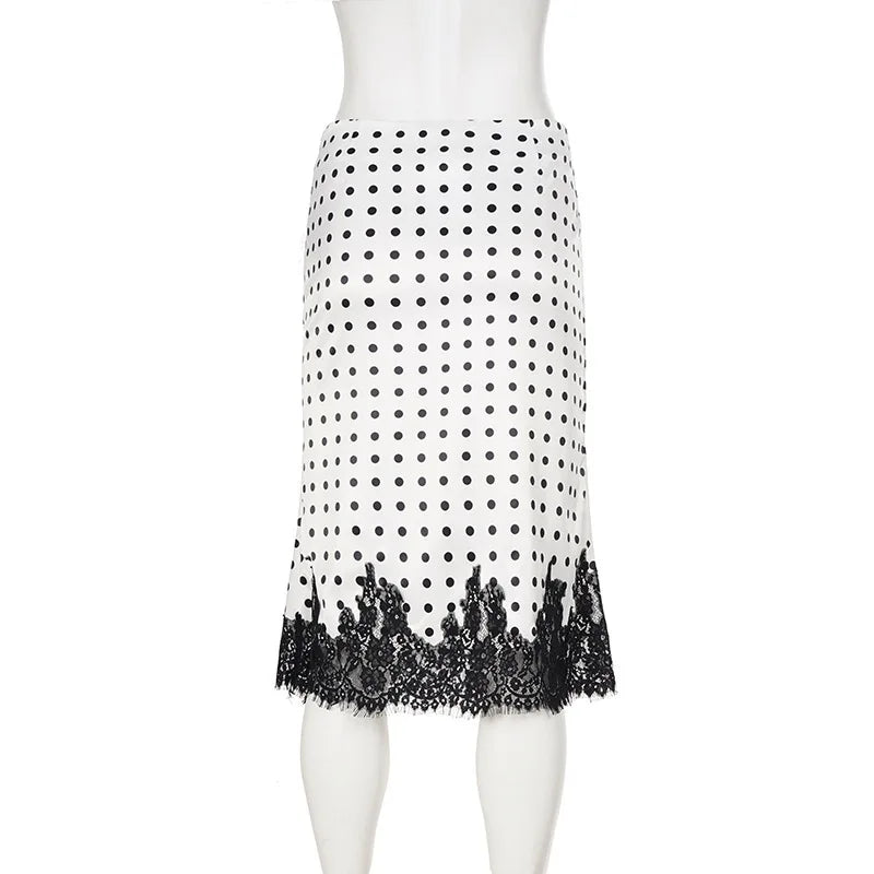 White skirt with black polka dot pattern and lace trim on a mannequin against a white background