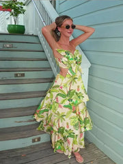 A woman wearing a colorful 3D floral ruffle maxi dress with a tiered skirt, ideal for summer events. 3