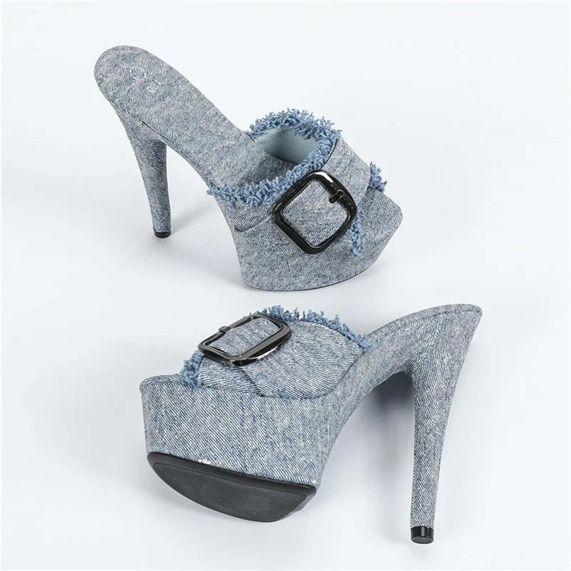 Pair of denim high-heeled shoes with buckles on a white background