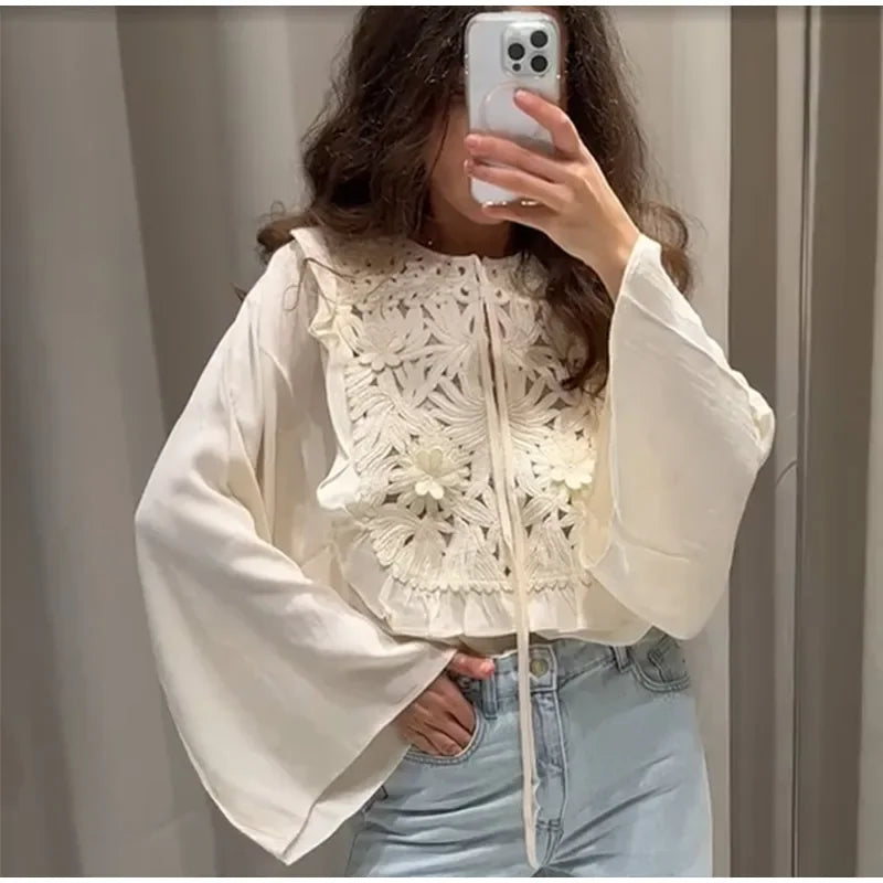 Floral embroidered blouse with flared sleeves and mini skirt.