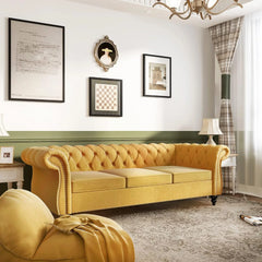 Yellow sofa in a stylish living room with framed pictures and a chandelier.