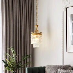 A charming French-style chandelier with a retro copper finish and crystal accents, hanging in a cozy living room.