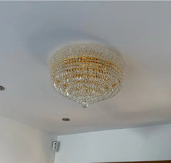 Chandelier hanging from a ceiling in a room with a wooden door.