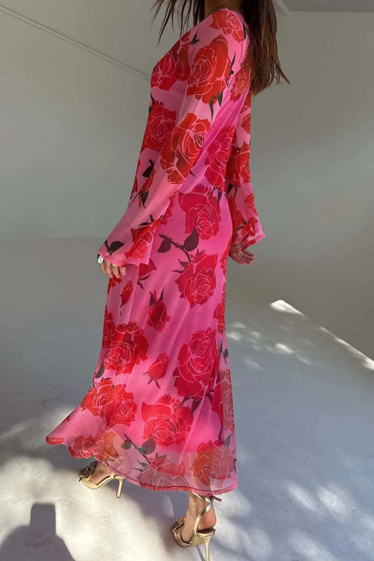 Person wearing a pink and red floral dress on a white background