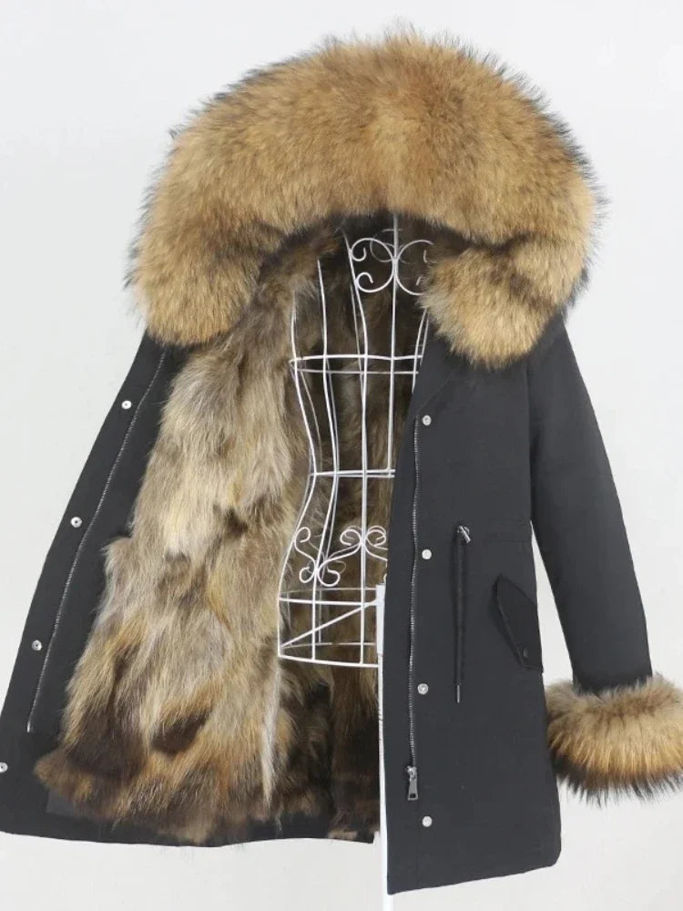 Black coat with fur hood and cuffs on a mannequin against a white background