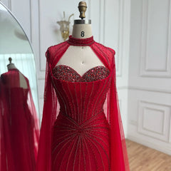 Red evening gown with beaded details on a mannequin against a white wall.