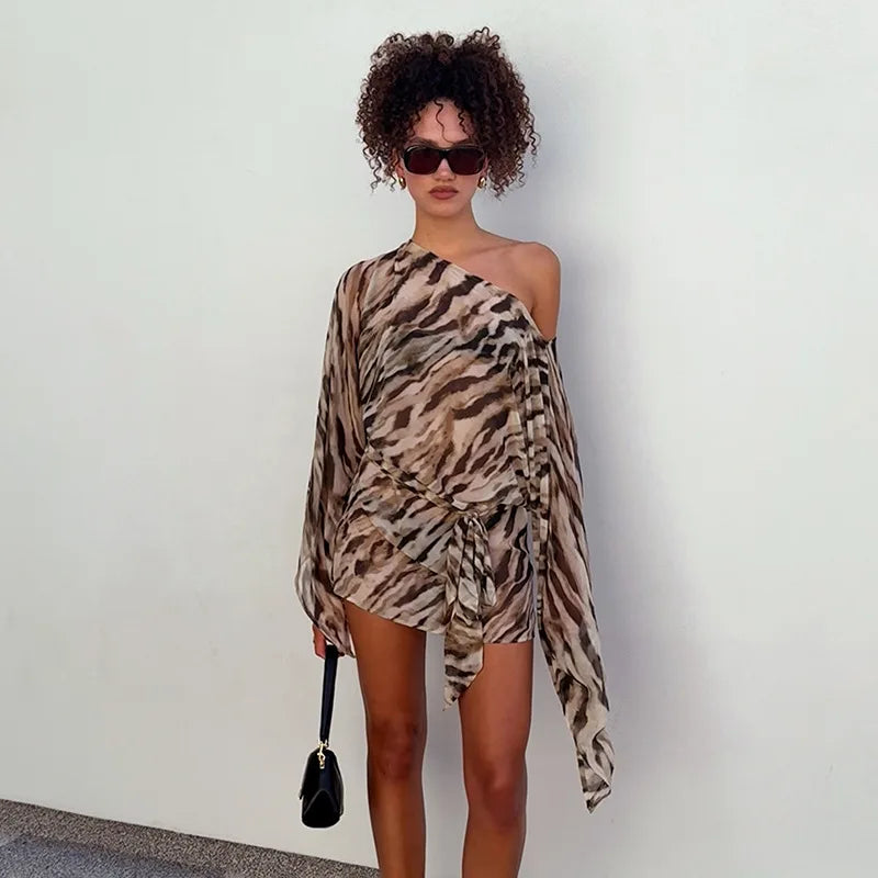 One-shoulder zebra print mini dress styled with sunglasses