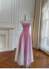 Pink A-line midi dress with white lace paneling and spaghetti straps displayed on a mannequin.