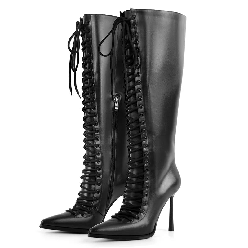 Side profile of lace-up pointed toe knee-high boots in black faux leather