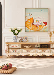 Decorative living room with floral-themed furniture and wall art.