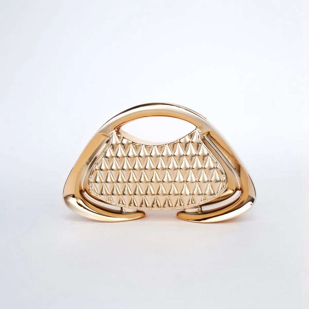 Gold handbag with pyramid pattern on a light gray background