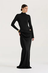 Woman wearing a black long-sleeve gown on a white background