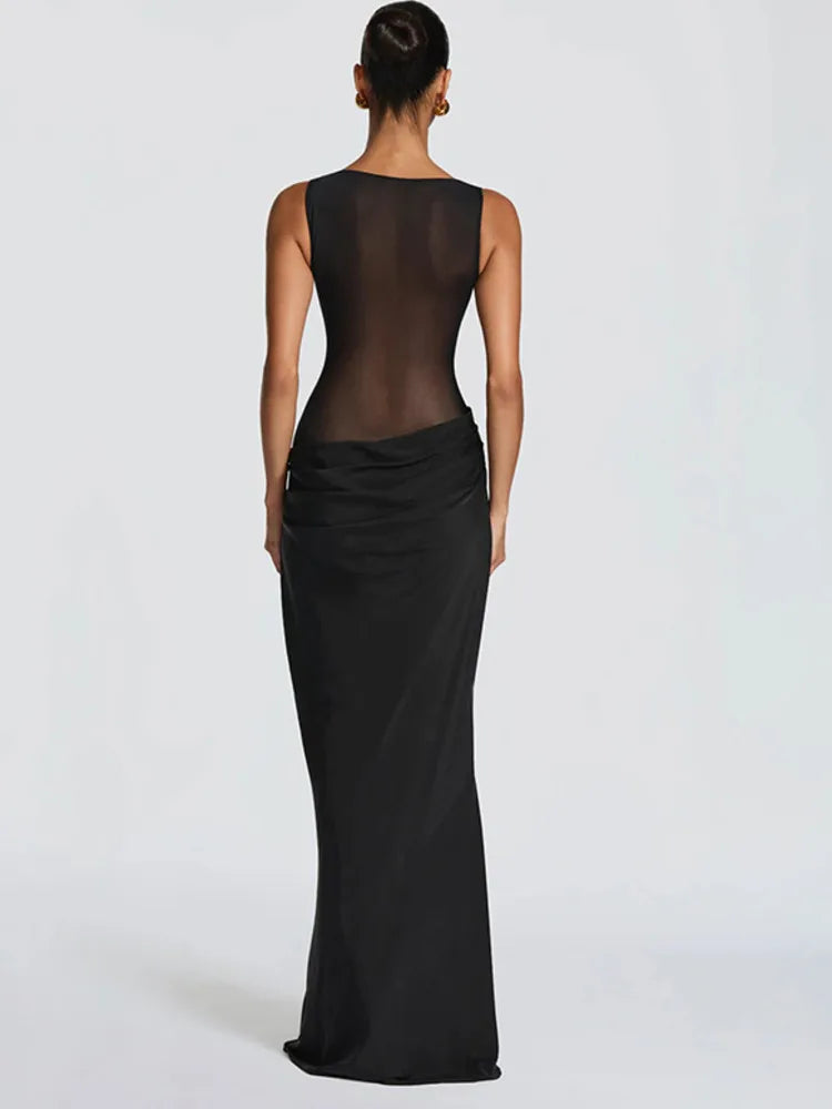 Black evening gown with sheer back on a white background