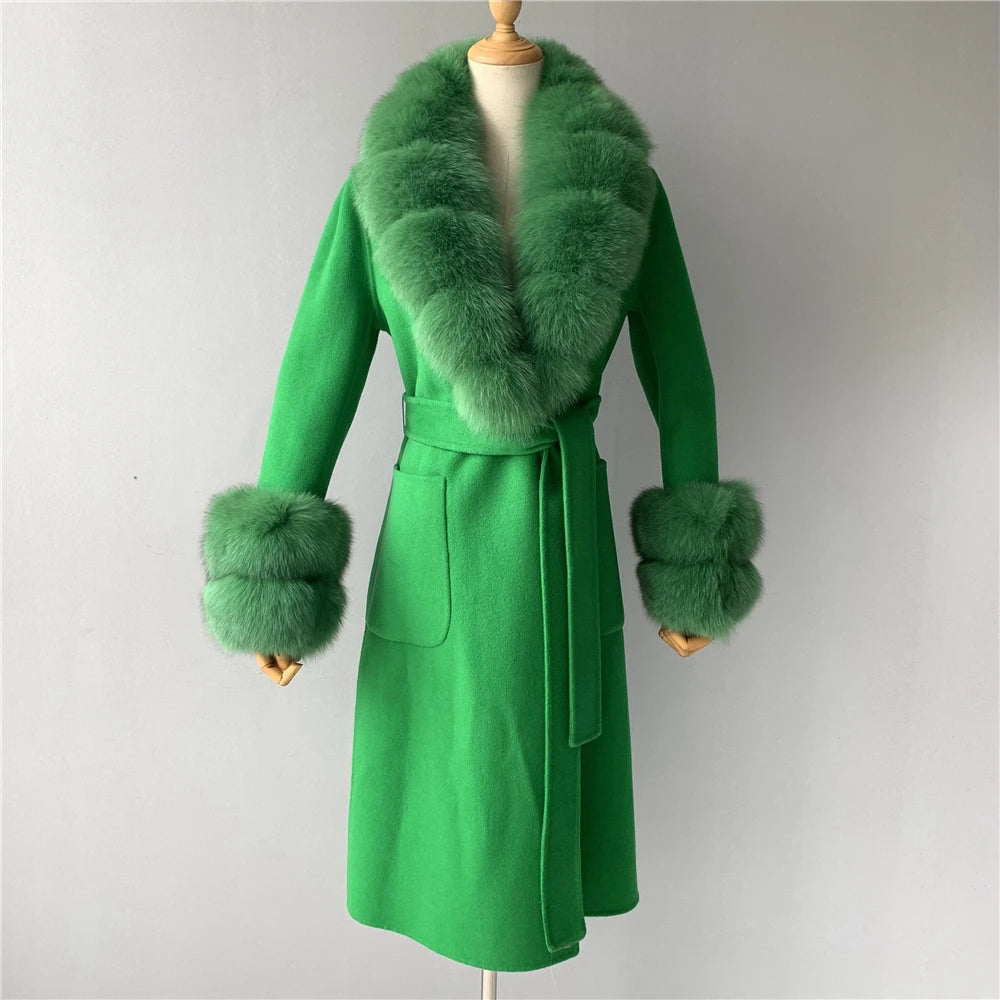 Green coat with fur collar and cuffs on a mannequin against a gray background