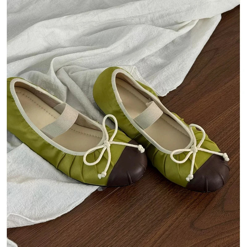 Close-up of green satin ballet flats