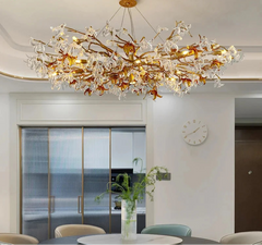 Luxurious chandelier hanging in a modern interior setting with a clock on the wall.