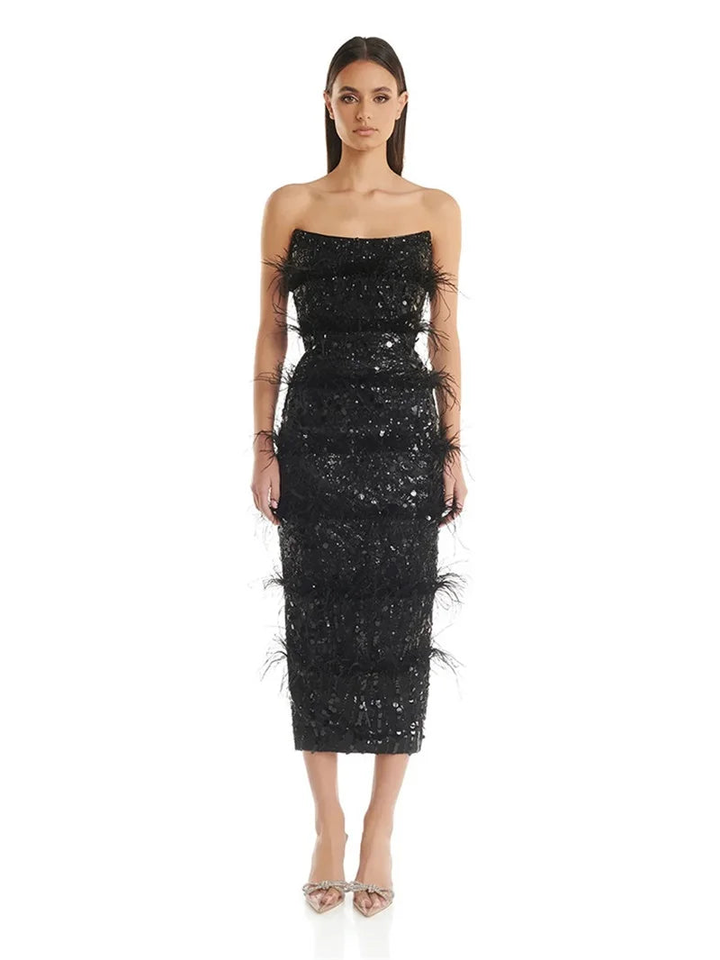 Black sequin and feather strapless evening gown, front view.