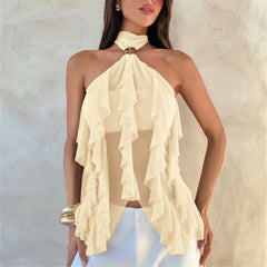 Woman wearing a beige halter top with ruffled details against a neutral background