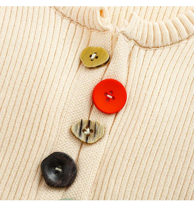 Close-up of colorful buttons on ribbed knit top