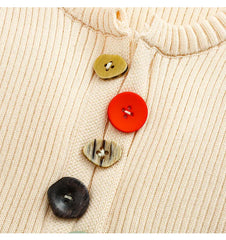 Close-up of colorful buttons on ribbed knit top