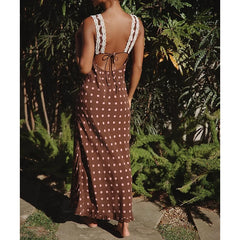 Back view of a polka dot maxi dress with lace trim and tie-back.