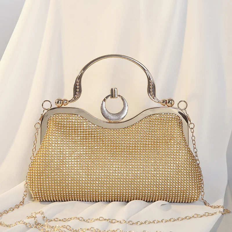 Gold crystal-encrusted clutch bag with ring handle and chain