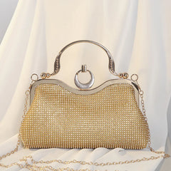 Gold crystal-encrusted clutch bag with ring handle and chain
