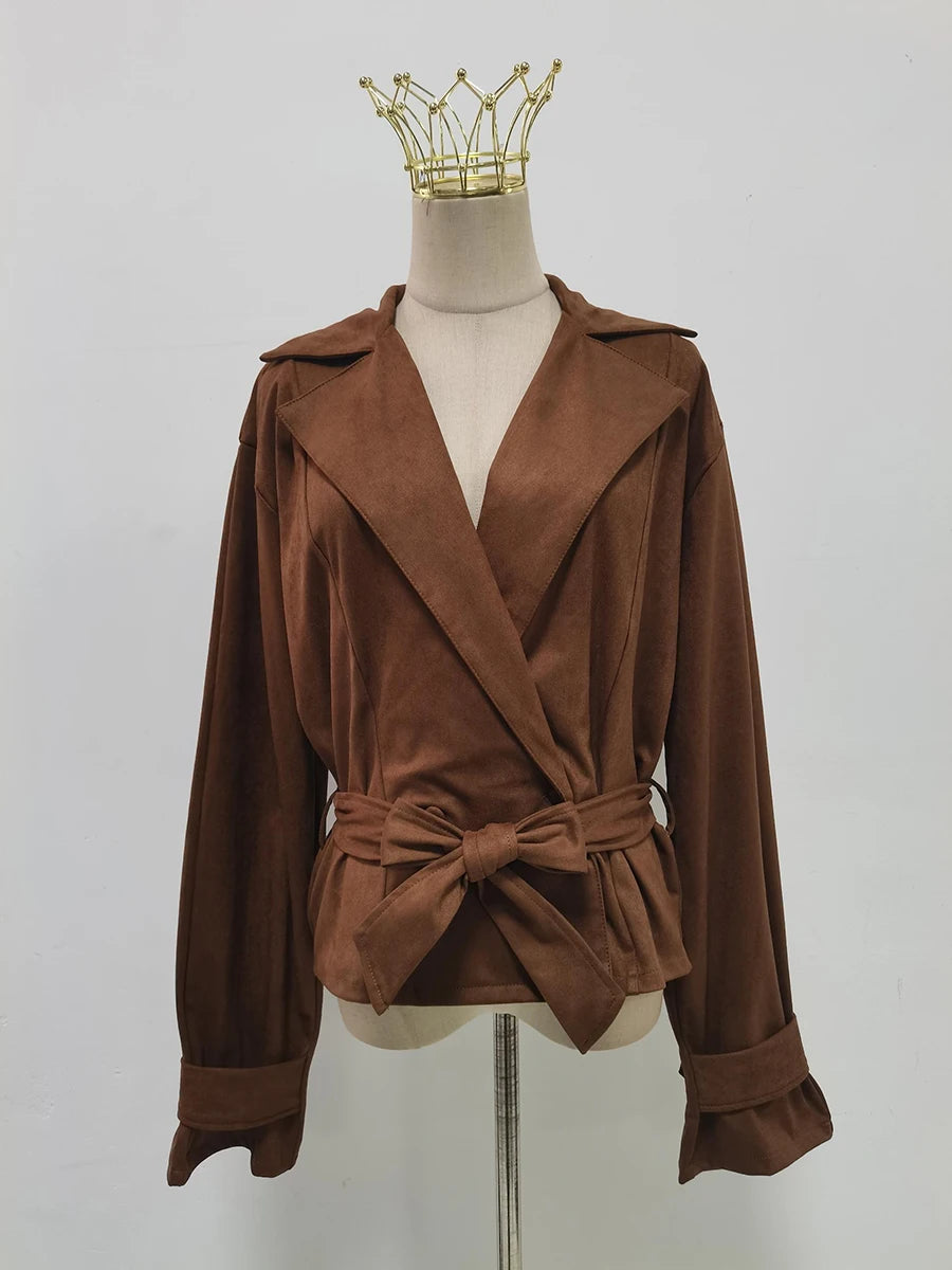 Brown jacket with a belt on a mannequin against a plain background