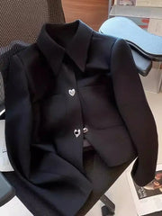 Black blazer with heart-shaped buttons on a chair