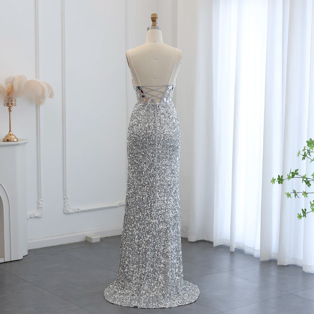 Silver sequin dress on a mannequin against a white curtain background