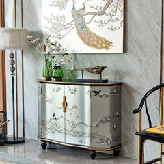 Decorative cabinet with floral patterns in a room with a peacock painting on the wall.