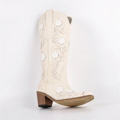 White cowboy boot with floral embroidery on a white background
